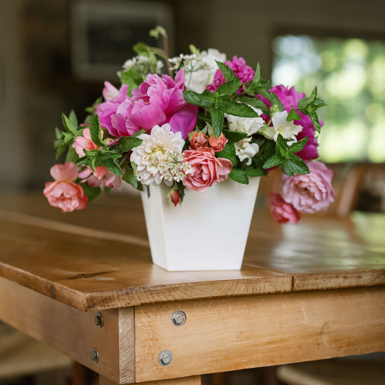 tapered large cube with spring arrangement with daylilly and peonies
